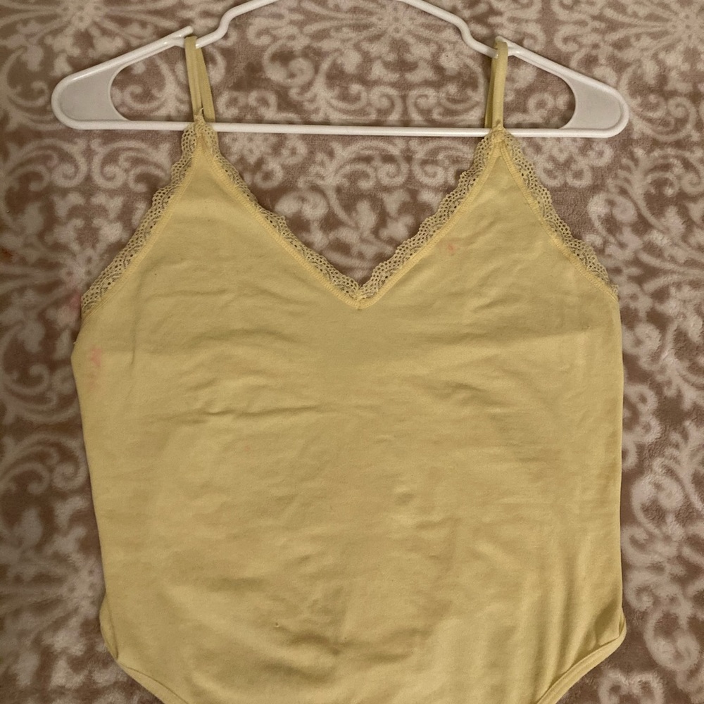 Pale yellow spaghetti strap body suite.